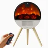 A hand holding a remote control is shown in the foreground, with a circular electric fireplace on a tripod stand in the background. Produktbild-Vorschau