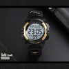 A close-up shot of a digital watch with a black strap and gold accents, displayed on a dark background. Produktbild-Vorschau