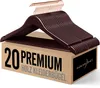 A stack of brown wooden hangers with rose gold hooks, resting on a cardboard box with product information. Produktbild-Vorschau