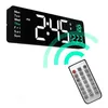 A digital clock and a remote control are shown against a white background. Náhled obrázku produktu