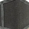 A close-up view of the corner of a cat scratching post made of dark gray sisal rope and trimmed with gray plush fabric. Produktbild-Vorschau