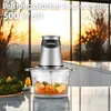 A food chopper is shown on a kitchen counter with chopped vegetables in its glass bowl. In the background, a sunset is visible through large windows. Produktbild-Vorschau