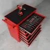A red tool cart with several drawers open, displaying various tools like screwdrivers and a drill on top. Voir les images du produit