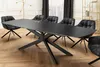 A modern dining room with a black extendable dining table and chairs. Produktbild-Vorschau