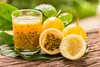 A glass of passion fruit juice and passion fruits on a wooden surface. Podgląd zdjęcia produktu