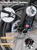 Close-up of an e-bike's front wheel and braking system, with text overlays highlighting features. Produktbild-Vorschau