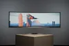 A curved gaming monitor is displayed on a pedestal against a plain gray background. Náhľad obrázku produktu