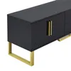 A close-up, angled view of a black TV cabinet with gold legs and handles, set against a white background. Produktbild-Vorschau