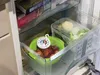 A thermometer placed inside a refrigerator drawer, showing the temperature of the food within. Podgląd zdjęcia produktu