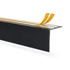 A black corner profile with yellow adhesive tape being peeled off. Podgląd zdjęcia produktu