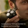 A person is using a black electric shaver to trim their sideburns. Podgląd zdjęcia produktu