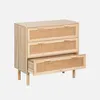 A light wood dresser with rattan drawer fronts against a light gray background. Produktbild-Vorschau