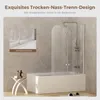 A modern bathroom scene featuring a bathtub with a shower screen, a small side table with toiletries, and slippers on the floor. Podgląd zdjęcia produktu