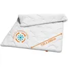 A white quilted blanket is shown laid out diagonally on a white background. Produktbild-Vorschau