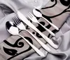 A set of silverware laid out on a patterned cloth. Produktbild-Vorschau