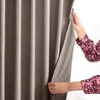 Hands holding a curtain open to reveal more of the curtain behind it. Produktbild-Vorschau