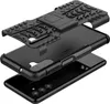 A disassembled black phone case with a kickstand, showing its three layers and the phone it is designed for. Produktbild-Vorschau