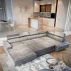 A spacious living room and kitchen area with a large sectional sofa in the foreground. Produktbild-Vorschau