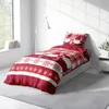 A bedroom scene with a bed dressed in festive Christmas bedding. Produktbild-Vorschau