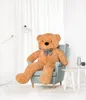 A large teddy bear sits in a chair in a well-lit room. Podgląd zdjęcia produktu