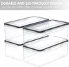 A stack of clear plastic food storage containers with black lids. Produktbild-Vorschau