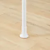 A close-up view of the white adjustable base of a telescopic clothes rack, resting on a light wood floor. Náhľad obrázku produktu