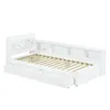 A white daybed with a slatted mattress base and two integrated storage drawers. The headboard features multiple shelf compartments. Produktbild-Vorschau