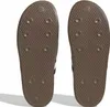 The soles of two brown Adidas Puffylette sneakers are shown from an underneath view. Podgląd zdjęcia produktu