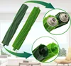 Two green vacuum cleaner brush rolls are shown against a bright, slightly blurred background of a room with windows. Close-up insets highlight the ends of the brush rolls. Produktbild-Vorschau