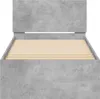 A bed frame with a concrete gray finish and wooden slats is shown against a white background. Podgląd zdjęcia produktu