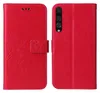 A red flip phone case with a floral and butterfly design is shown open, displaying the inside and the camera cutout on the back. Produktbild-Vorschau