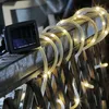 A solar-powered LED light strip coiled around a wooden railing. Produktbild-Vorschau