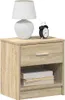 A bedside table with a lamp and an alarm clock on top, and books on the shelf below. Náhľad obrázku produktu