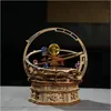 A wooden 3D puzzle model of a solar system or orrery, with colorful spheres representing planets, set against a dark background. Voir les images du produit