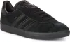A black Adidas Gazelle sneaker shown from a side angle. Voir les images du produit