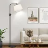 A modern living room scene with a floor lamp, sofa, and coffee table. Anteprima dell’immagine prodotto