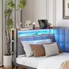 A bed with a headboard featuring integrated LED lighting and a shelf with decorative items and a tablet. Anteprima dell’immagine prodotto