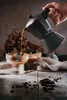 Coffee being poured from a moka pot into glasses of ice cream. Náhľad obrázku produktu