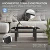 A set of black table legs is shown in a living room setting with a sofa and coffee table. Náhled obrázku produktu