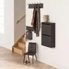 An entryway with a shoe cabinet, coat racks, a chair, and stairs. Anteprima dell’immagine prodotto