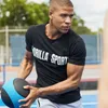 A man is holding a medicine ball during an outdoor workout. Produktbild-Vorschau