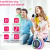 A family is enjoying karaoke together in a living room setting. Produktbild-Vorschau
