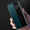 A hand holding a smartphone with a smart view flip case, displaying the time and weather. Produktbild-Vorschau