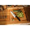 A kitchen scene with a knife and sliced cucumbers on a cutting board. Podgląd zdjęcia produktu