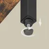 A close-up view of the adjustable foot of a black metal furniture leg, with a wooden surface visible in the upper left corner. Produktbild-Vorschau