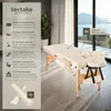A massage table and stool set displayed in a room with a large window overlooking a body of water and mountains. Náhled obrázku produktu