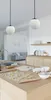 A kitchen island with baking ingredients and cookie dough, with pendant lights hanging above. Produktbild-Vorschau