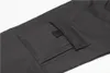 A close-up view of a dark gray cargo pocket on a pair of pants. Produktbild-Vorschau