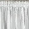 A close-up view of white sheer curtains hanging from a curtain rod. Produktbild-Vorschau