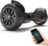 A black hoverboard with large tires and red accents is shown on a white background. A hand holding a smartphone displaying a control app is in the foreground. Produktbild-Vorschau
